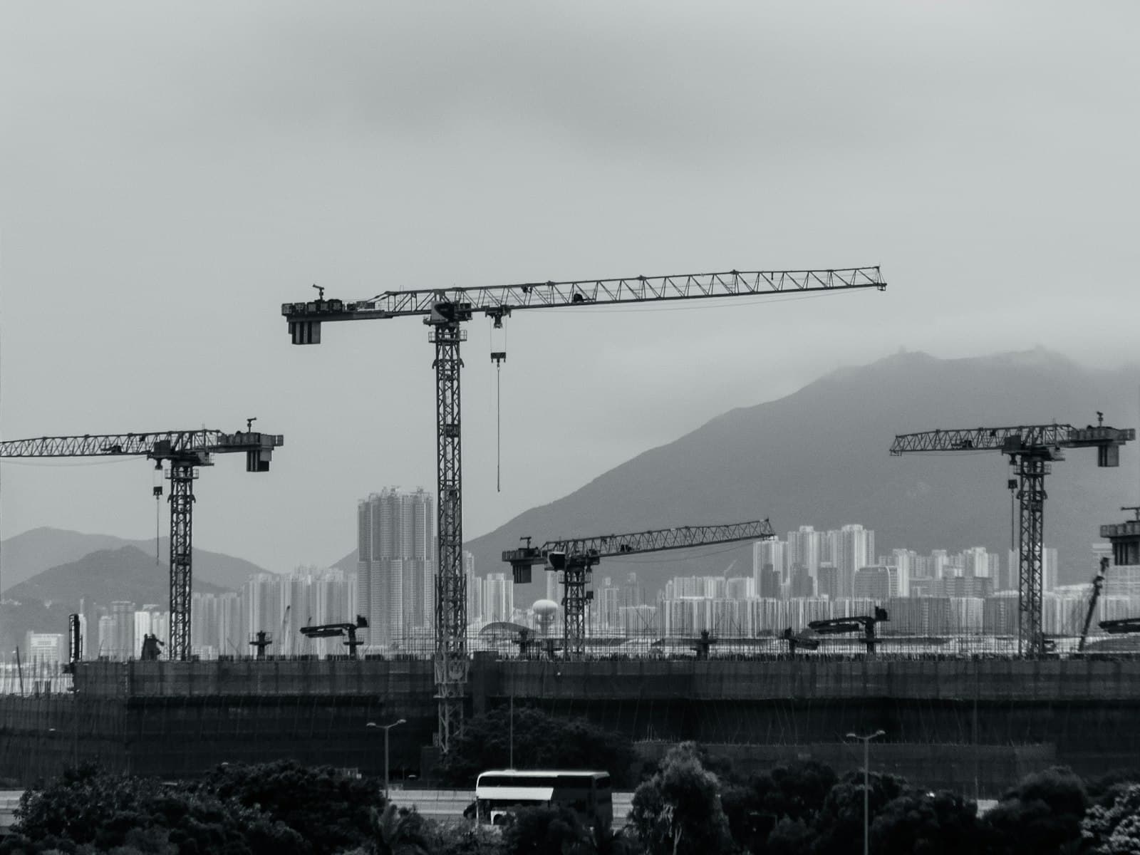 Tower cranes across a city construction skyline